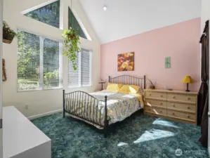 1 of 2 secondary bedrooms. This one offers vaulted ceilings.