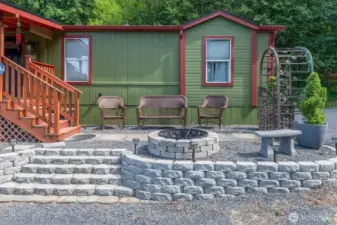 Firepit and sitting area in fron of the home overlooking the pasture.