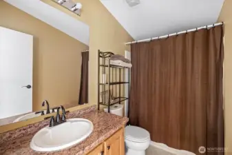 Main bathroom with tub and shower combo.