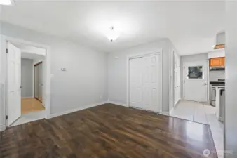 Top of entry, this is the formal dining room area. Door to hallway (open @ left); door to entertainment deck (with window @ right). Spacious storage closet at center.