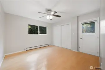 One of two bedrooms on main level. Exterior door leads to deck.