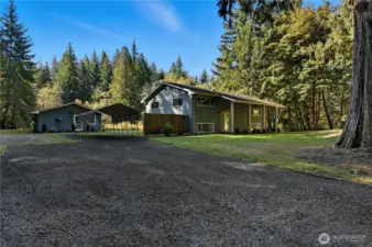 Side of home from upper driveway ... RV Parking with power & septic, plus carport. ADU at left
