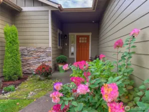Pretty plantings along the paved pathway to the front door.