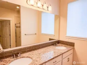Double vanity, walk-in closet and walk-in shower in primary bath.