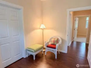 Opposite corner of the third bedroom, hallway and doorway to the primary bedroom.