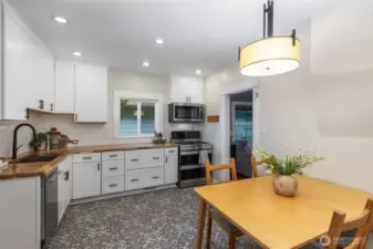 The remodeled kitchen has Spanish tile floors, butcher block counters, new cabinetry and new dishwasher