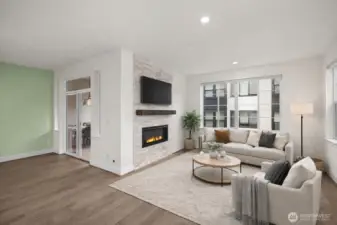 A wall of windows floods the great room with natural light while the fireplace provides warmth.