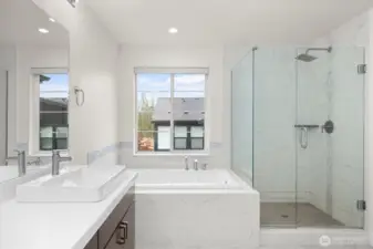 The primary bathroom feels like a private retreat, featuring a luxurious soaking tub and a spacious standalone shower.