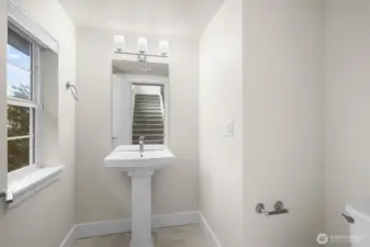 The powder bathroom is stylish and well-appointed, offering a polished touch that’s perfect for guests.