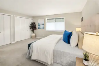 Another view of the primary suite highlights the expansive layout, providing plenty of room for a king-sized bed and additional seating.