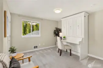 Bright and airy, this multi-functional room provides a quiet place to work with a view of the lush greenery outside