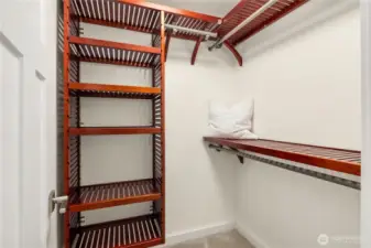 ou’ll never run out of space in this professionally organized walk-in closet, featuring custom wood shelving and multiple hanging rods for a high-end boutique feel.