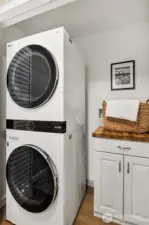 New washer and dryer room includes folding and storage space