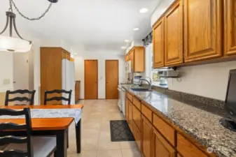 Large kitchen features two pantry areas, eating area and beautiful cabinetry with quartz counter tops.