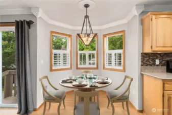 Virtually staged breakfast nook. Elegant hanging light fixture and ceiling medallion, plantation shutters and light fixture are real.