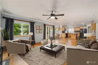 Virtually staged family room and kitchen. Center ceiling fan and bamboo flooring & drapes are real.