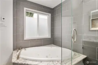 Primary bath has elegant glass door shower & tiled radiant heated flooring. Comfy-cozy.