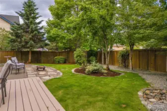 Completely fenced back yard with fire-pit. Well appointed with Aspen trees for privacy and balanced with matured landscaping.