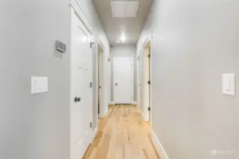 Hallway off the kitchen leads to pantry, laundry room, bathroom and two more bedrooms.