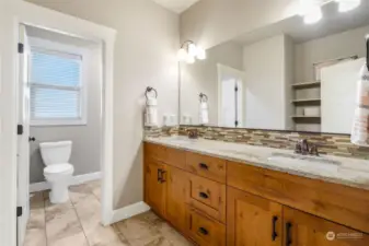 Hall bath with dual sinks. Separation door allows for privacy of multiple users.