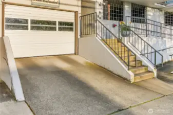 garage entry and additional steps into the building on the right