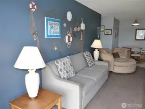 Hide-a-bed couch and beachy decorations.