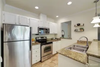 Granite counters and SS appliances make this kitchen very appealing.
