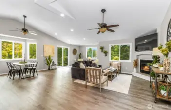 Walking into the open concept living room with fireplace. Home comes with the TV