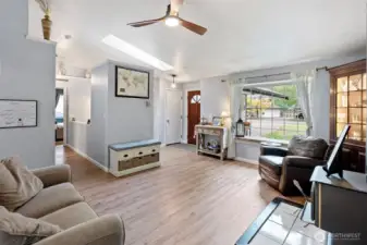 Another view of the living room with an adorable bench seat next to the front window for a fun cozy reading nook.