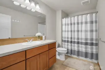 Main level full bath serves guests and the 2 bedrooms on this level. Virtually staged.