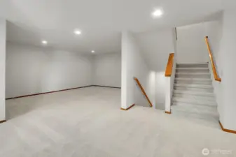 Staircase on the main level leads up to the 2nd floor and down to the garage.