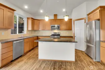 The generously sized kitchen is fully equipped with plenty of cabinets, a walk-in pantry, and modern stainless steel appliances, all of which are included with the home.
