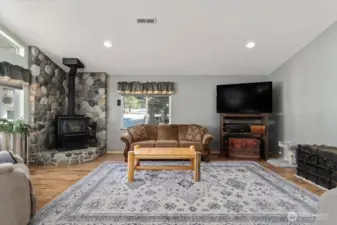 Living room with woodstove and river-rock.