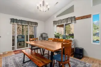 Dining room with sliding glass doors that lead to the screened-in porch.