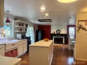 From the kitchen, looking to the fireplace in the family room, the patio doors and the dining nook.