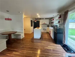This is the family room with its dining nook and sliding glass door to the covered patio. The kitchen is right beside the family room.