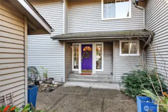 Inviting covered entry with charming door, sidelights & retractable screen door. Clean lines, neutral siding & cozy approach create warm curb appeal.