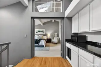 Spacious second-floor primary bedroom with vaulted ceilings & natural light. Private retreat with cozy sitting area & well-appointed layout.