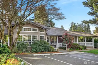 Alternate view of the community clubhouse with convenient guest parking nearby. Welcoming setting enhances gatherings, events & everyday neighborhood enjoyment.