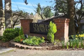 Charming entry monument for Pembrook Meadows, beautifully landscaped with seasonal color & mature greenery—creating a warm, inviting first impression as you arrive into this sought-after community.