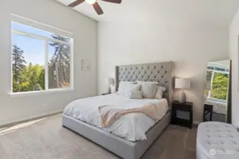 Large, vaulted ceiling  primary bedroom with ensuite and WIC