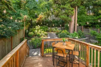 The deck is conveniently located right off the kitchen, leading to a tranquil backyard oasis.