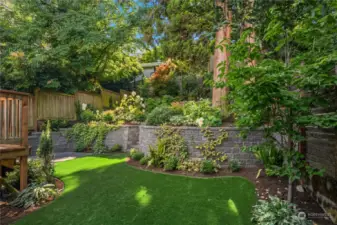 A complete yard transformation! The owners removed trees, added tiered retaining walls, installed high-end turf in the backyard, laid down pavers, and beautifully landscaped both the front and back areas.