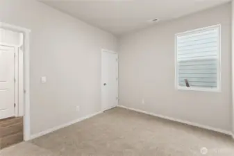 Main Floor Bedroom. Photos of previously built home of same floorplan. Colors, Specifications, and Options may vary on actual home.