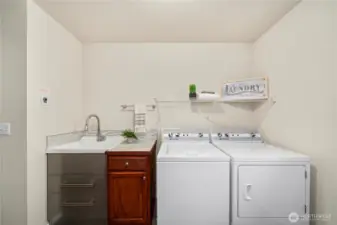 upstairs laundry rm is massive & includes a sink.