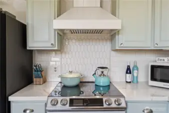 Custom range hood & tilework in kitchen
