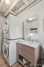 Stacked laundry machines in half bath