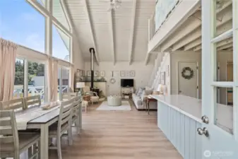 Open concept with super high vaulted ceiling, floor to ceiling windows & sliders to deck on East side