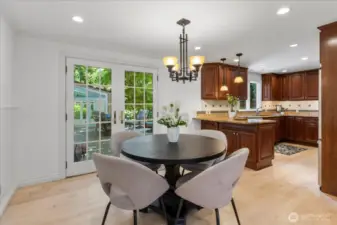 Eating area in between kitchen and dining room have french doors leading out to amazing outdoor space.
