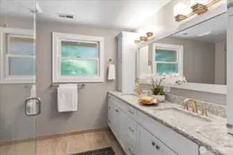 Spa styled bath features heated tile floors, solid surface counter tops and double sinks.